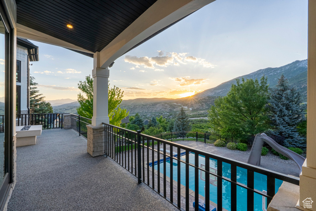 Balcony with a mountain view and view of pool