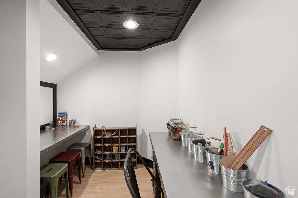 Office featuring an ornate ceiling and light wood-style floors