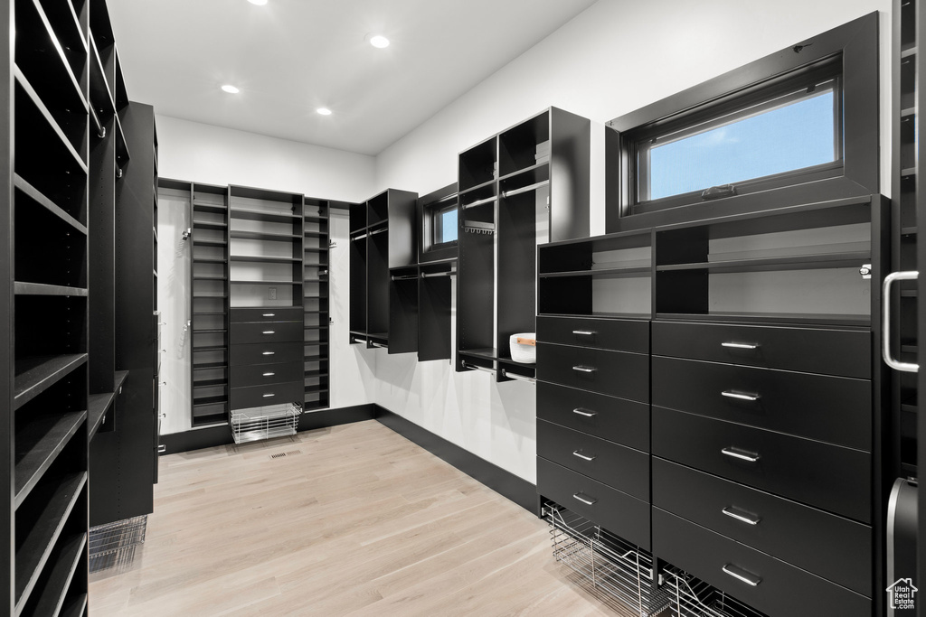 Spacious closet with light wood-style flooring