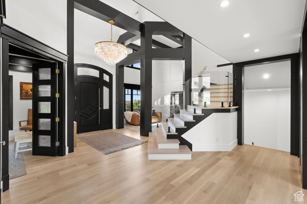Entryway with wood finished floors, a chandelier, and recessed lighting