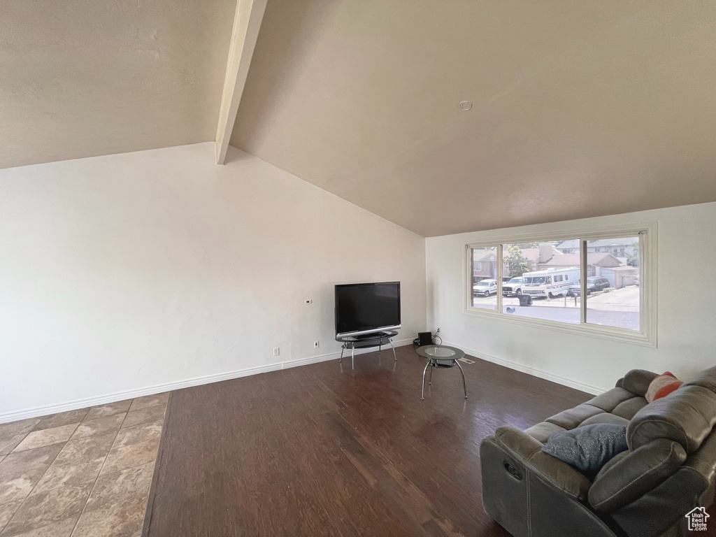 Living area with baseboards and wood finished floors