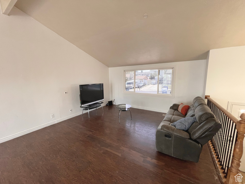 Living room featuring lofted ceiling and wood finished floors