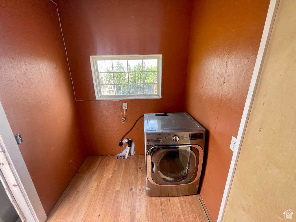 Laundry room featuring washer / clothes dryer and wood finished floors
