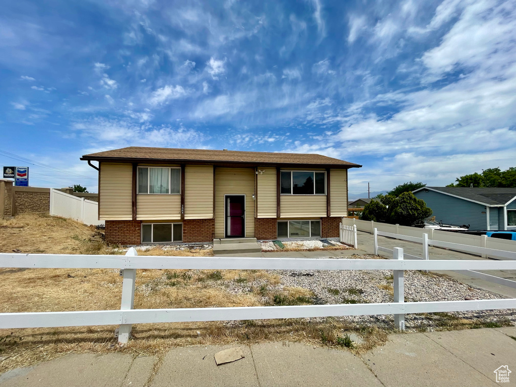 Split foyer home with a fenced front yard