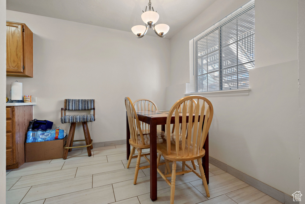 Dining space with a chandelier and baseboards