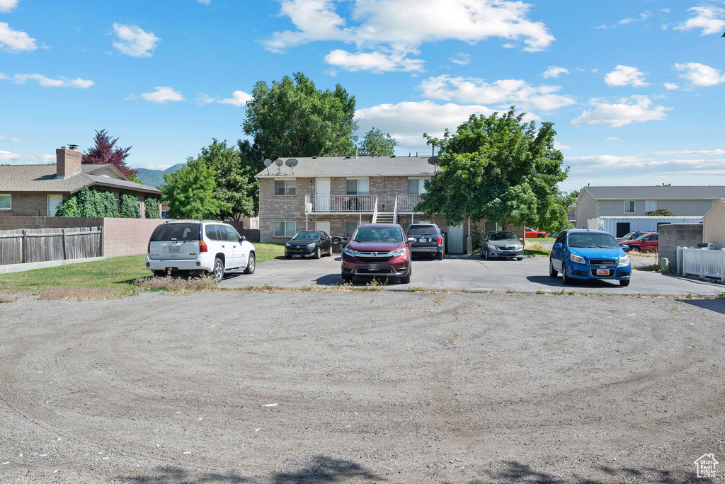 Uncovered parking lot featuring a residential view