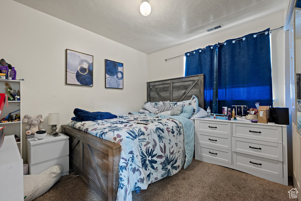Bedroom with light colored carpet