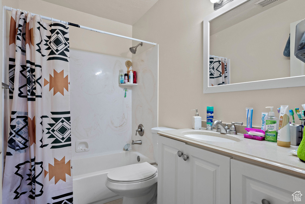 Full bathroom with vanity and shower / bath combination with curtain