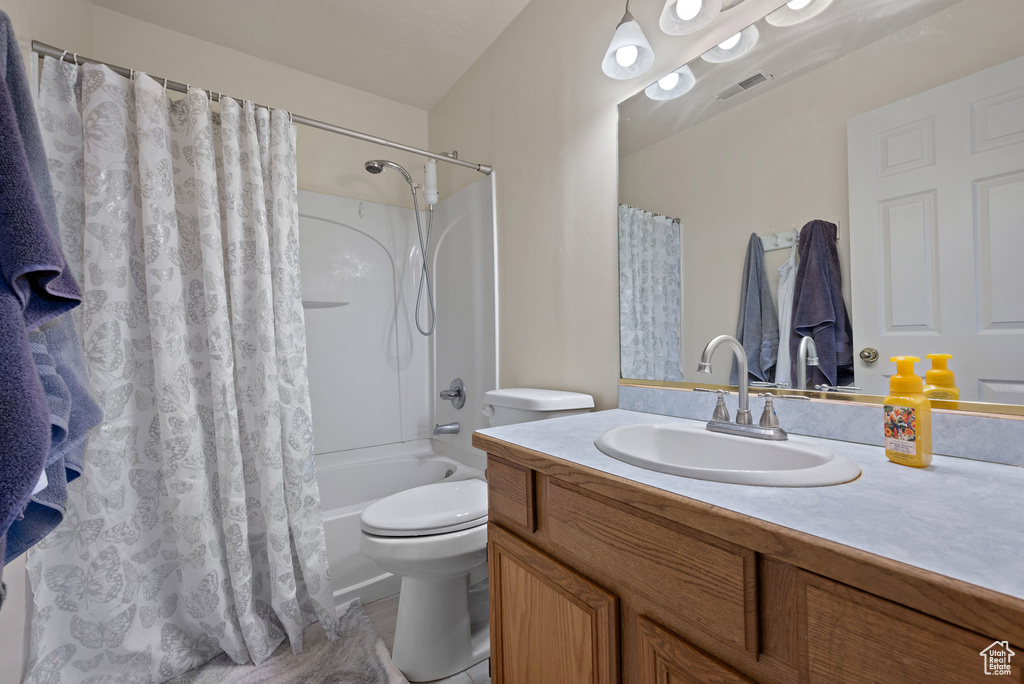 Bathroom with vanity and shower / bath combo with shower curtain