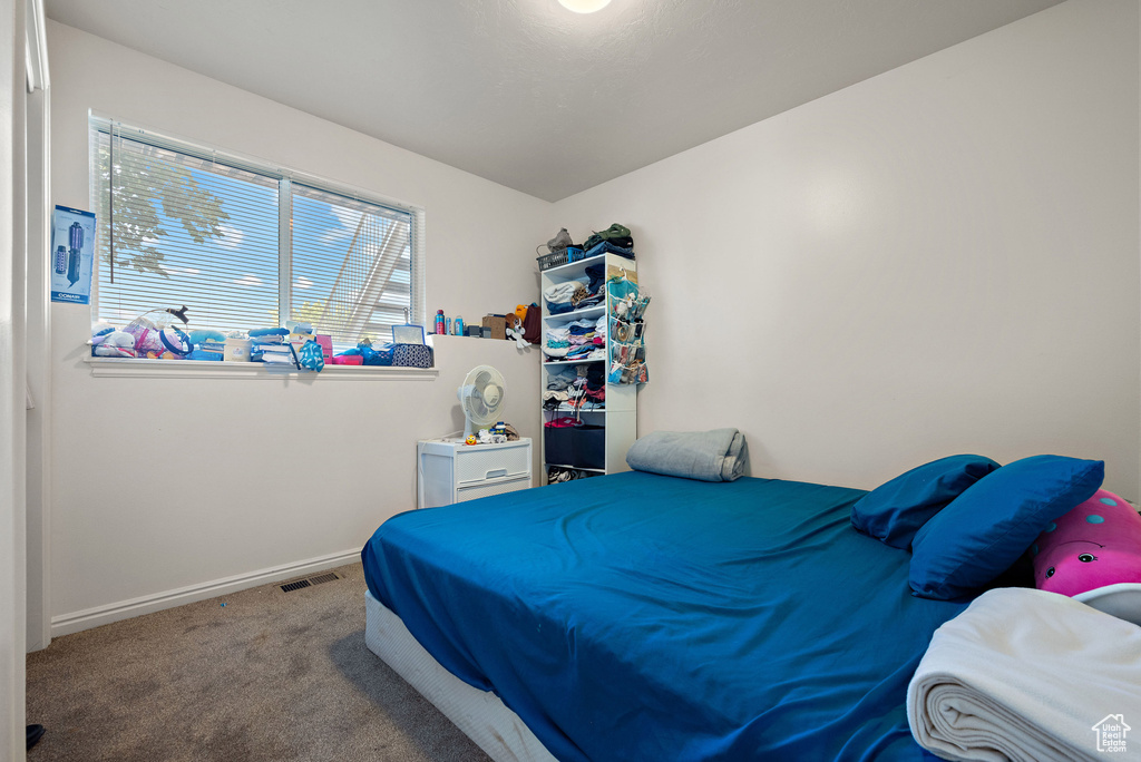 Carpeted bedroom featuring baseboards