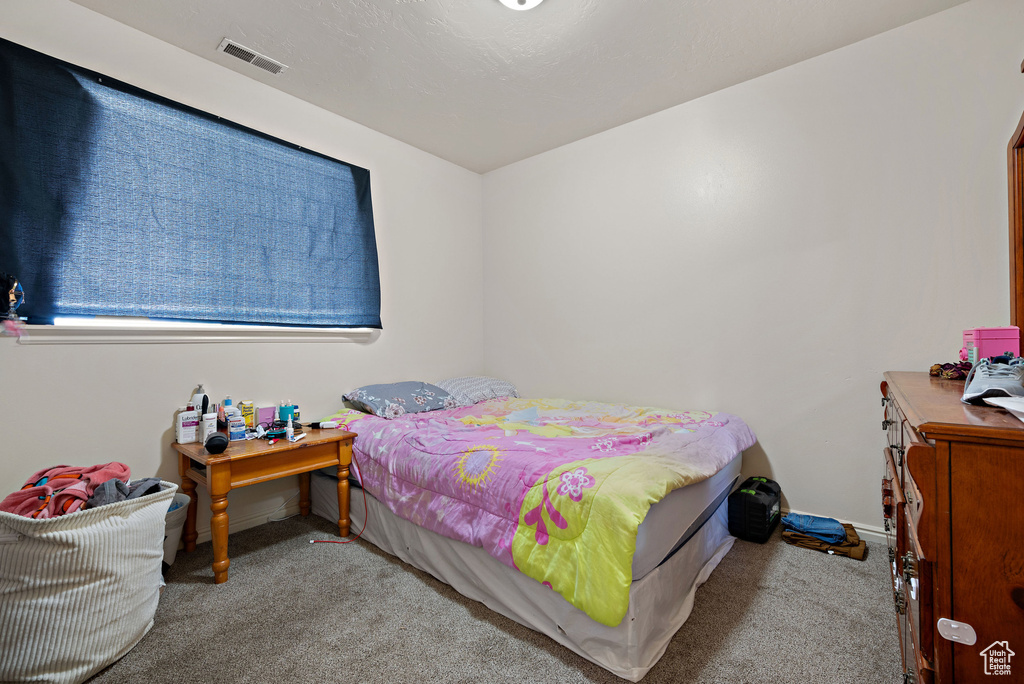 Bedroom featuring carpet floors and baseboards