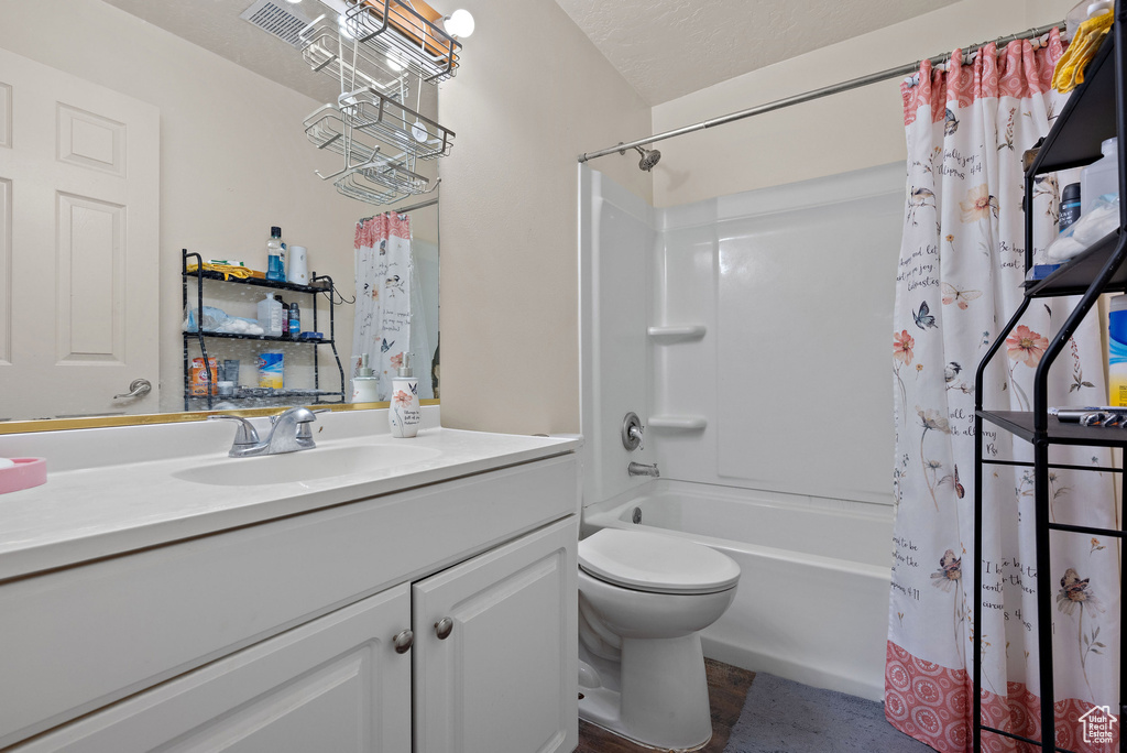 Bathroom featuring vanity and shower / tub combo with curtain