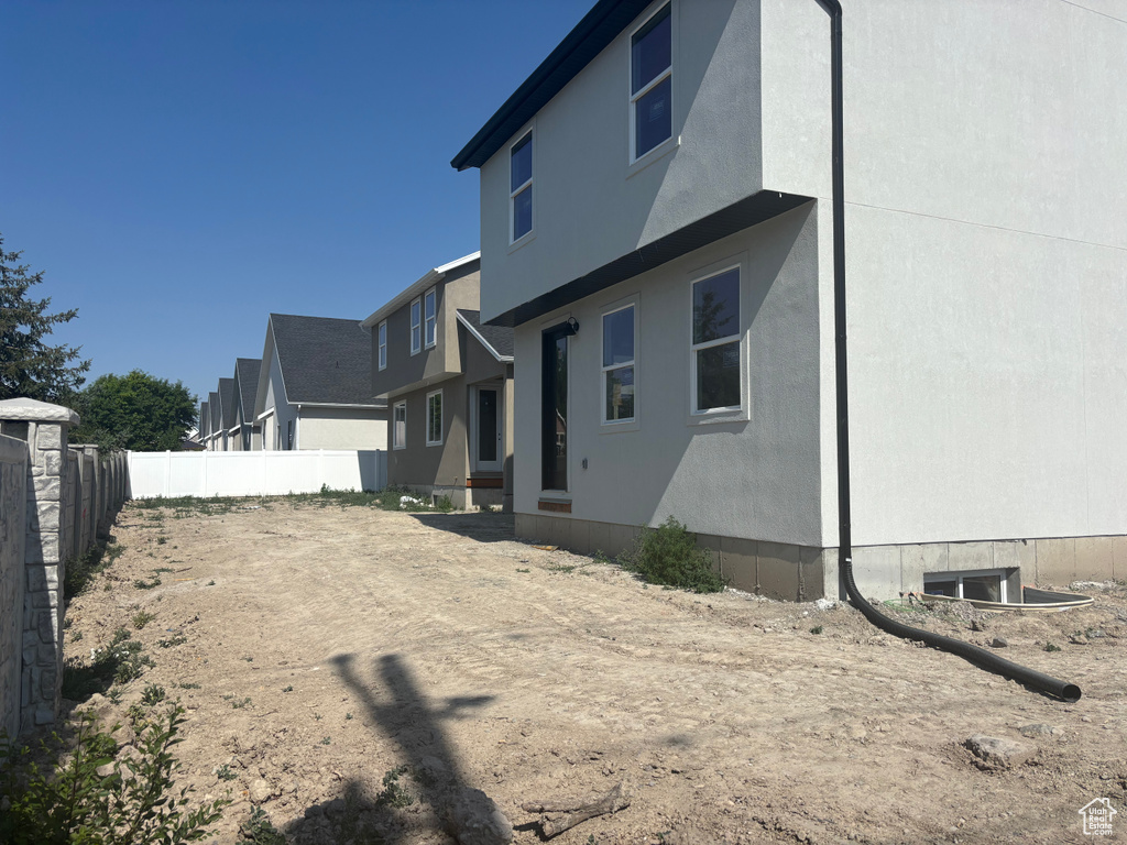 Rear view of house featuring stucco siding