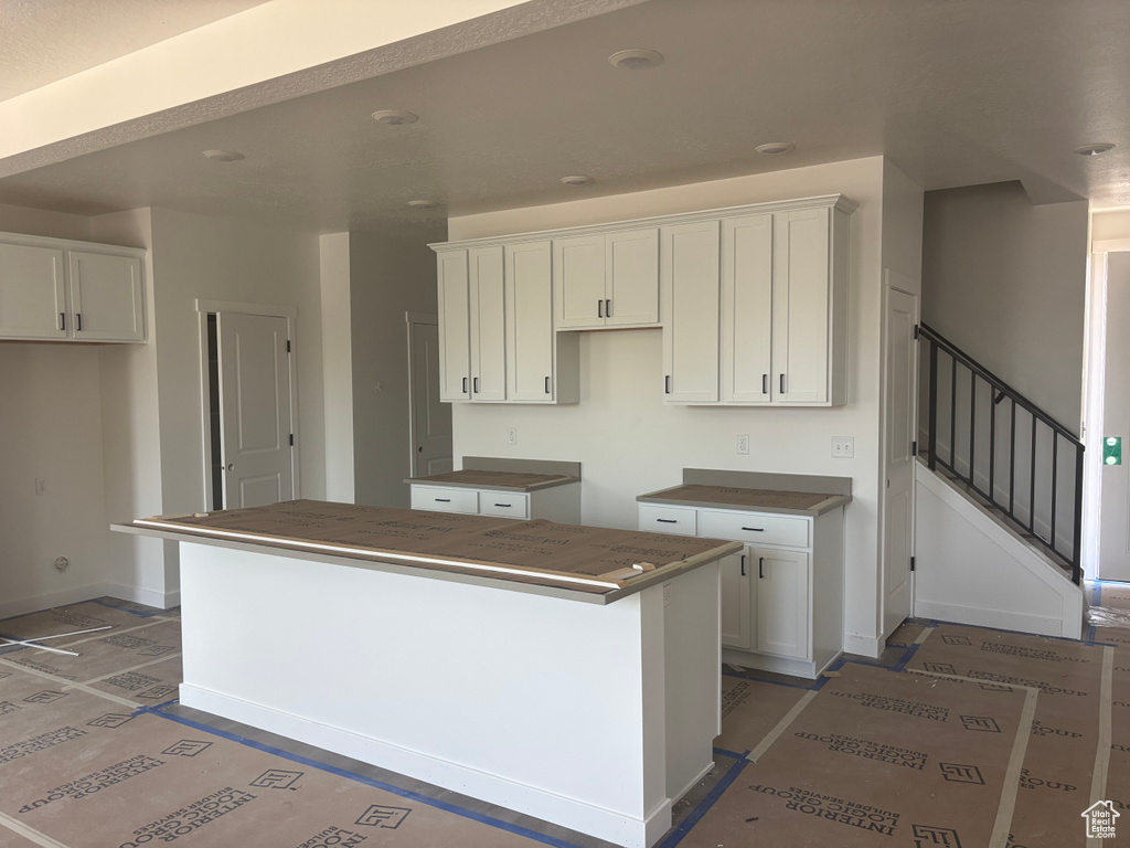 Kitchen with a kitchen island and white cabinetry