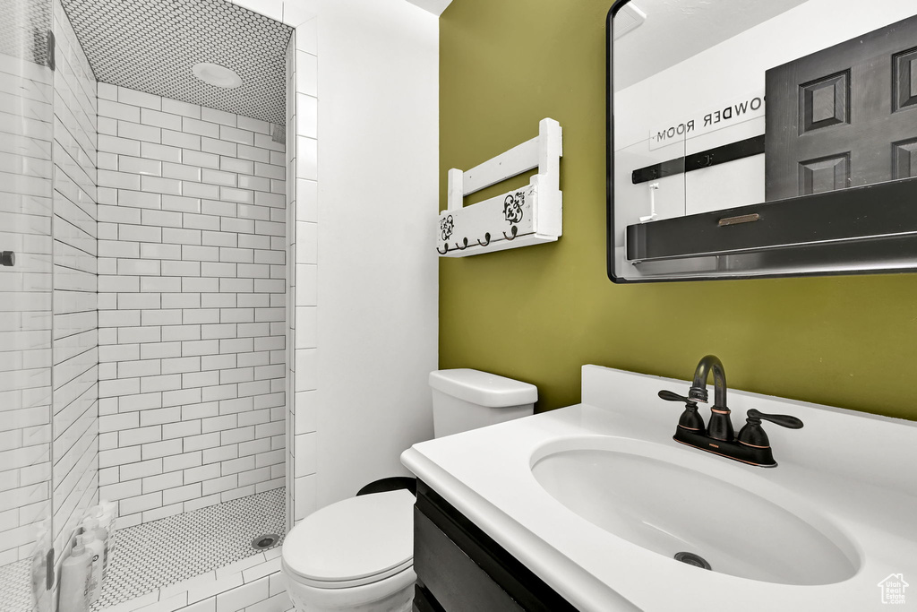 Full bath with a shower stall and vanity