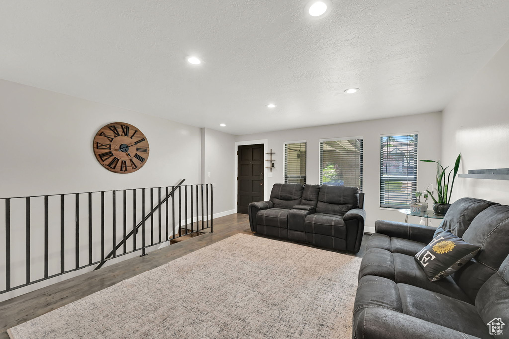 Living area featuring recessed lighting, wood finished floors, and a textured ceiling