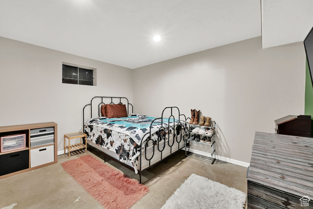 Bedroom featuring unfinished concrete flooring and recessed lighting
