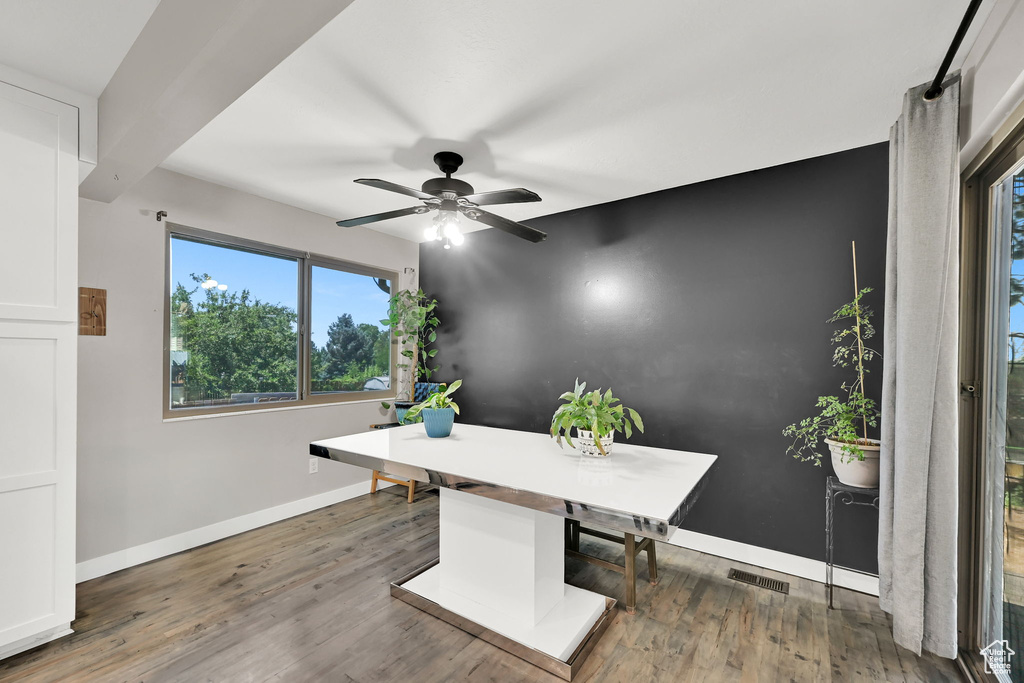 Unfurnished office featuring ceiling fan and wood finished floors