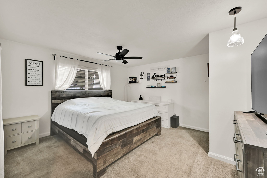 Bedroom featuring light carpet and ceiling fan