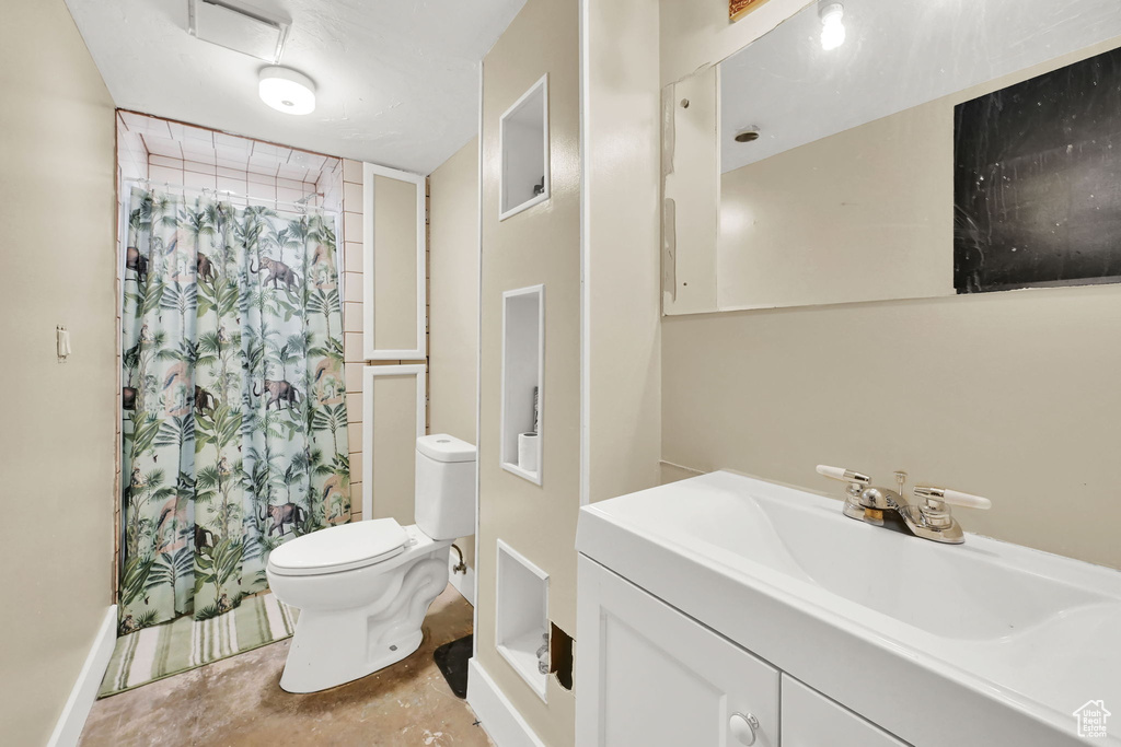 Bathroom featuring vanity, concrete floors, and a shower with curtain