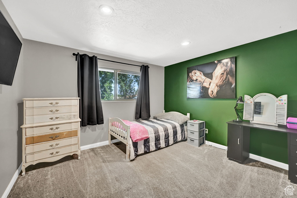 Bedroom with carpet, a textured ceiling, and recessed lighting
