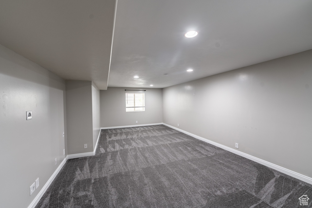 Below grade area featuring dark carpet and recessed lighting