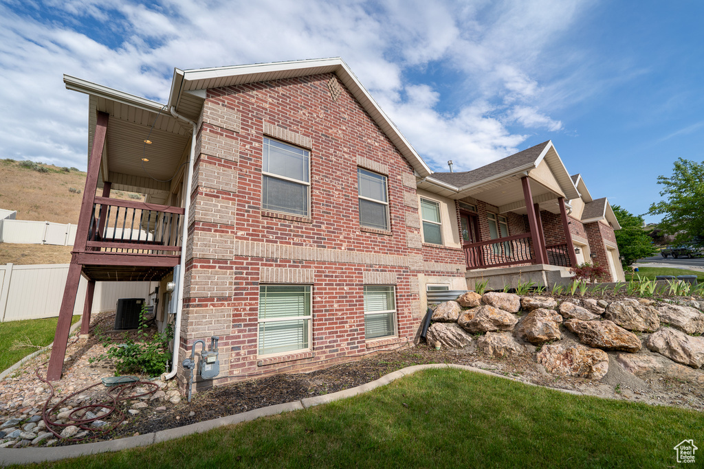 View of side of home featuring brick siding and a central air condition unit