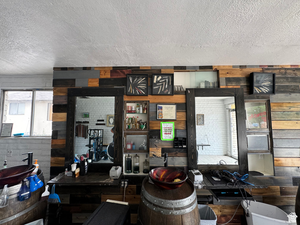 Interior space featuring a textured ceiling and wooden walls