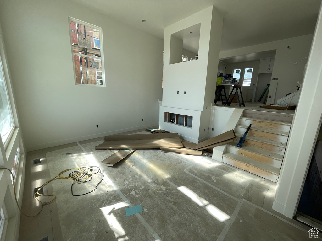 Unfurnished living room with baseboards