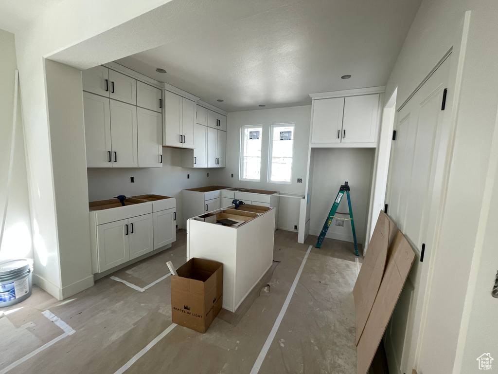 Kitchen featuring a center island and white cabinetry