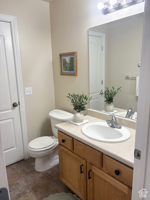 Half bathroom with vanity and toilet