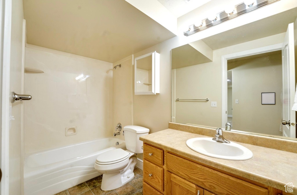 Full bathroom featuring vanity,  shower combination, and tile patterned flooring