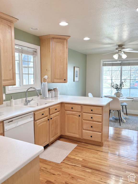Kitchen with light brown cabinets, dishwasher, light wood-type flooring, a peninsula, and recessed lighting