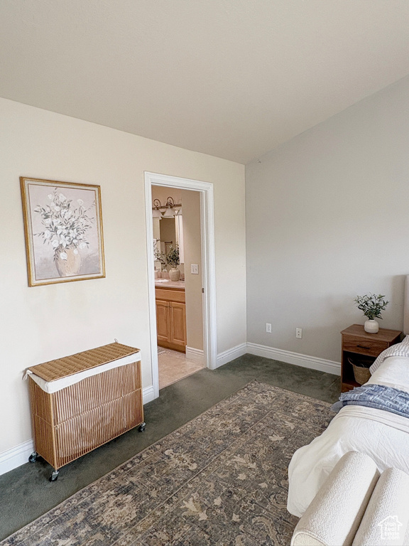 Bedroom featuring carpet flooring, radiator, and connected bathroom