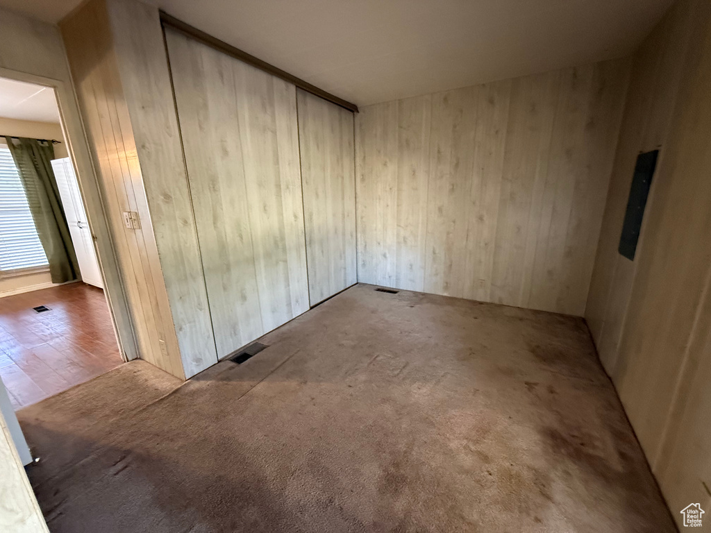 Unfurnished room with wooden walls