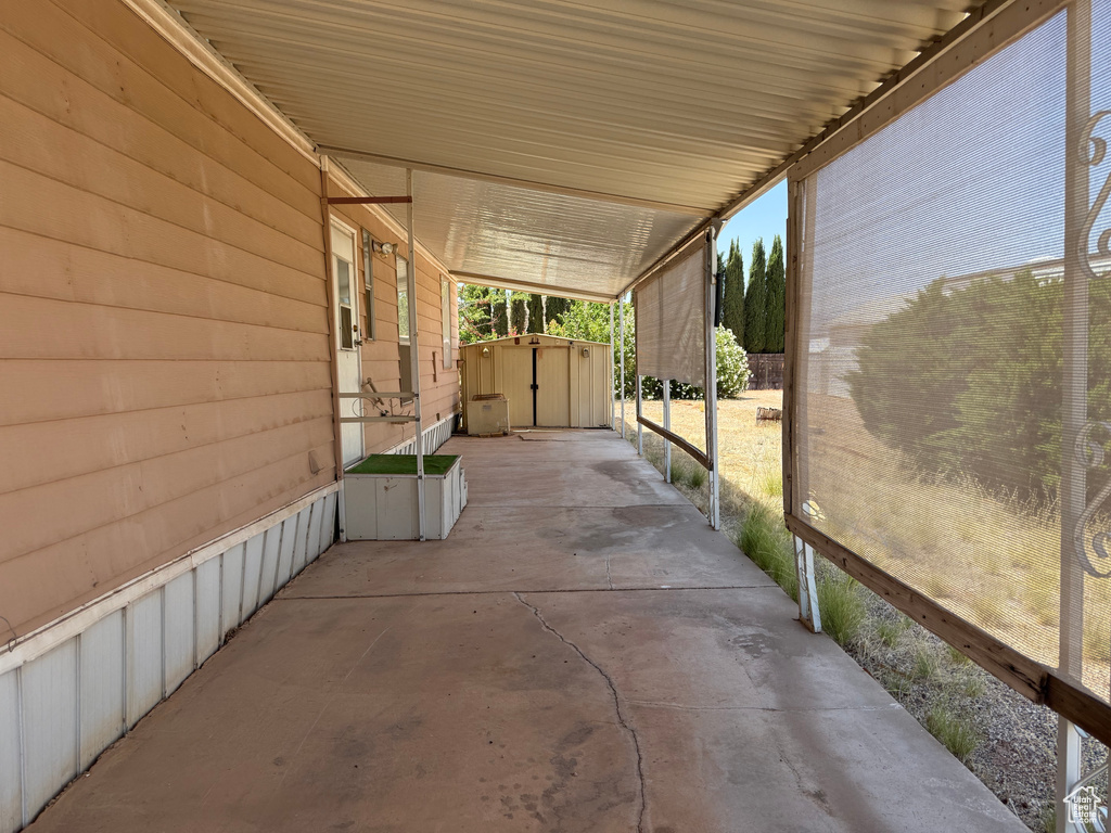 View of patio / terrace with a shed and a carport