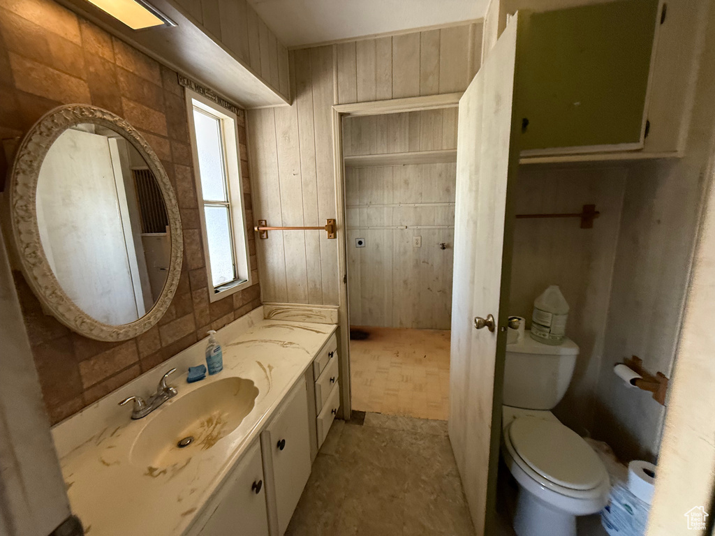 Bathroom with vanity and wooden walls