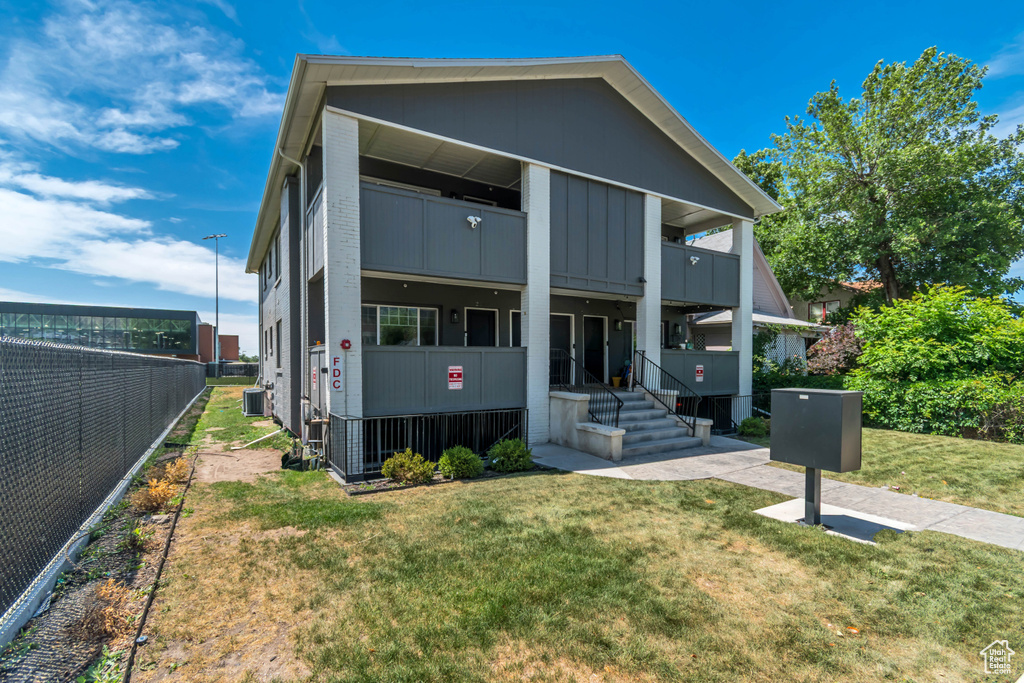 Contemporary house featuring a balcony and board and batten siding