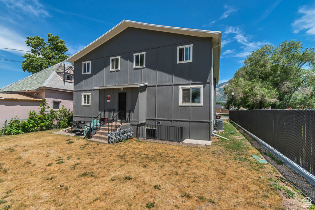 Rear view of property with a fenced backyard