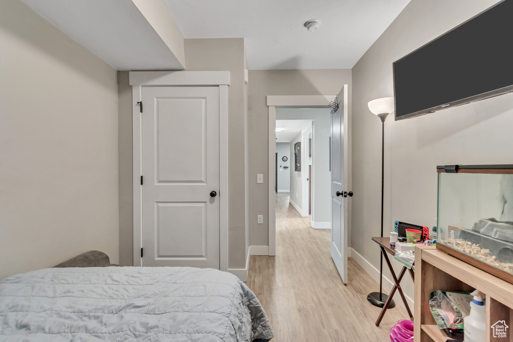 Bedroom with light wood-style flooring and baseboards