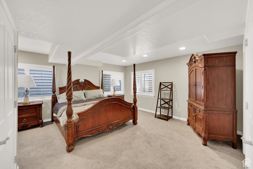 Bedroom featuring light carpet, recessed lighting, and baseboards