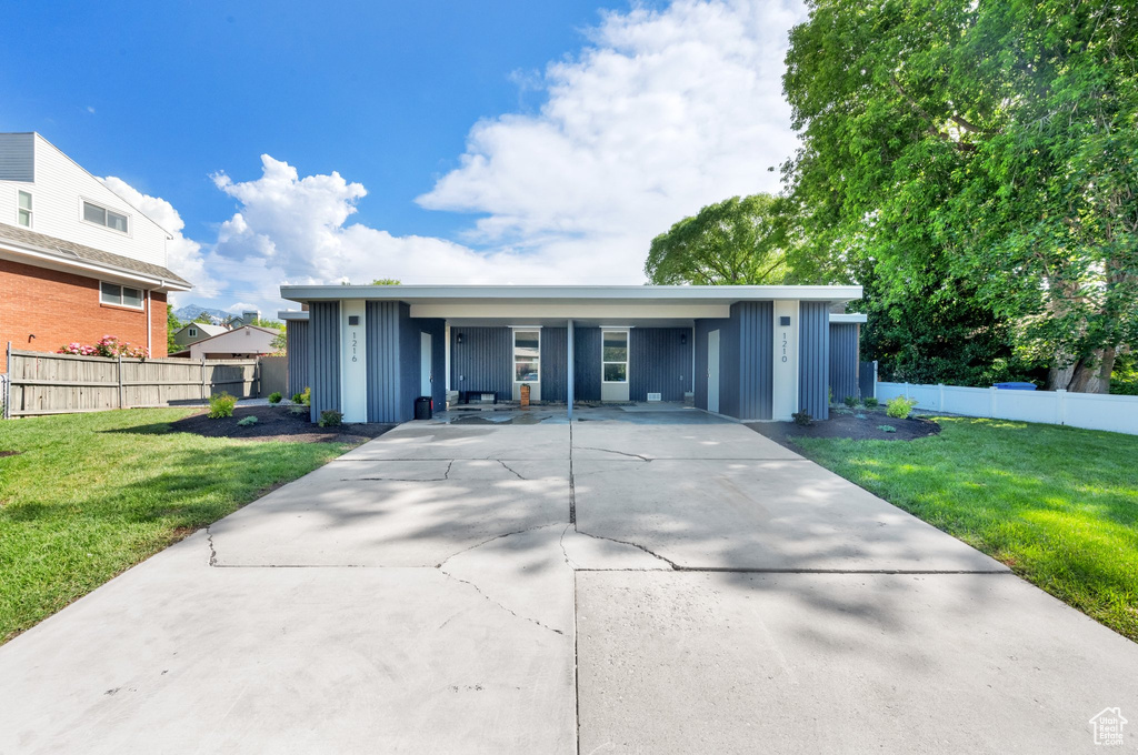 View of front facade featuring board and batten siding and concrete driveway