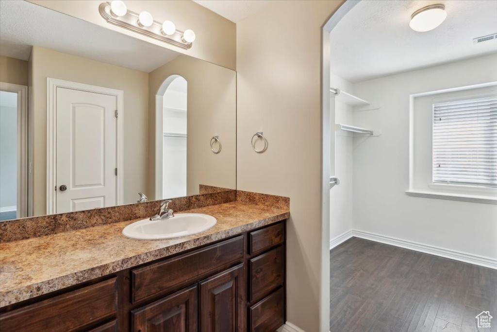 Bathroom featuring vanity and wood finished floors