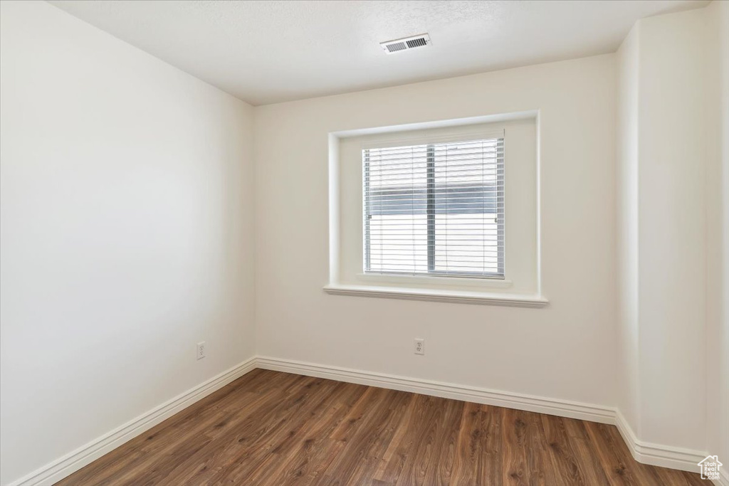 Spare room featuring wood finished floors