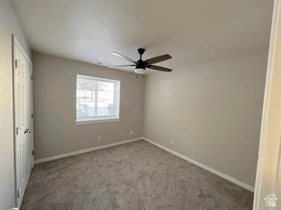 Unfurnished bedroom featuring carpet floors, ceiling fan, and a closet