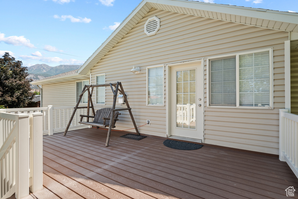Wooden deck featuring a mountain view