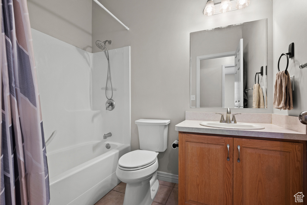 Bathroom featuring tile patterned flooring, vanity, and shower / bath combo with shower curtain