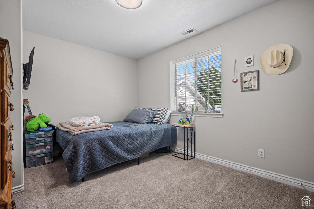 Carpeted bedroom featuring baseboards