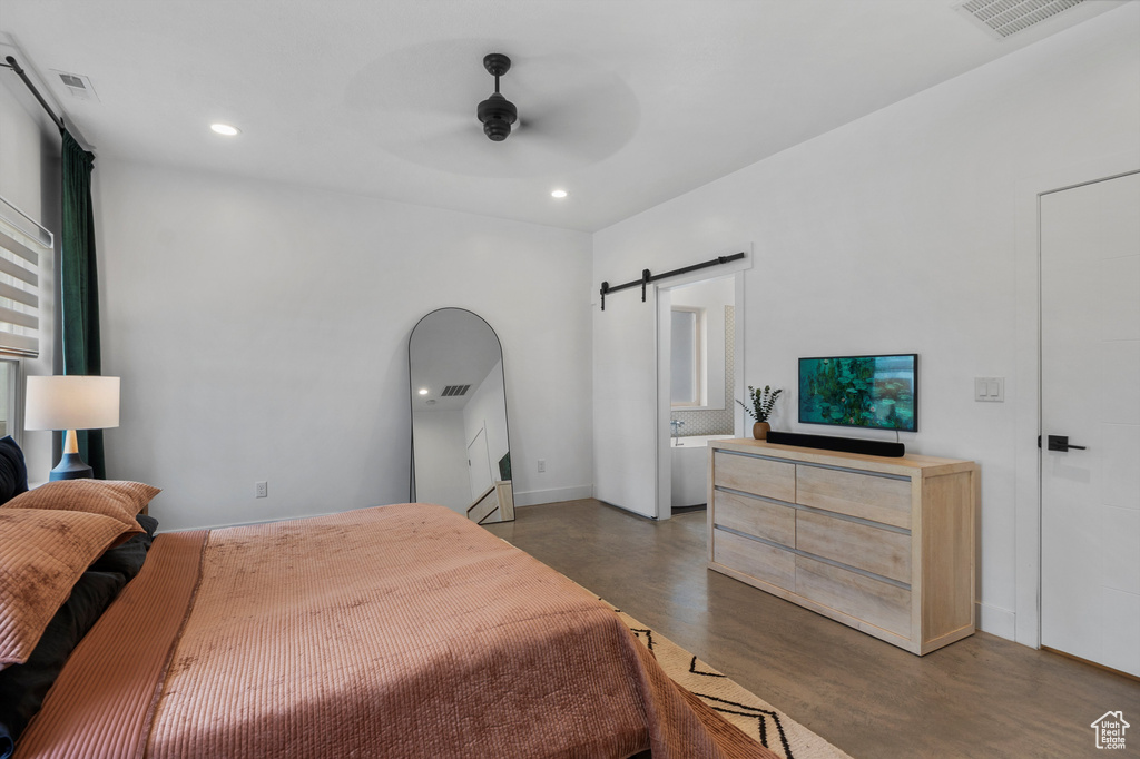 Bedroom featuring a barn door, recessed lighting, wood finished floors, and ceiling fan