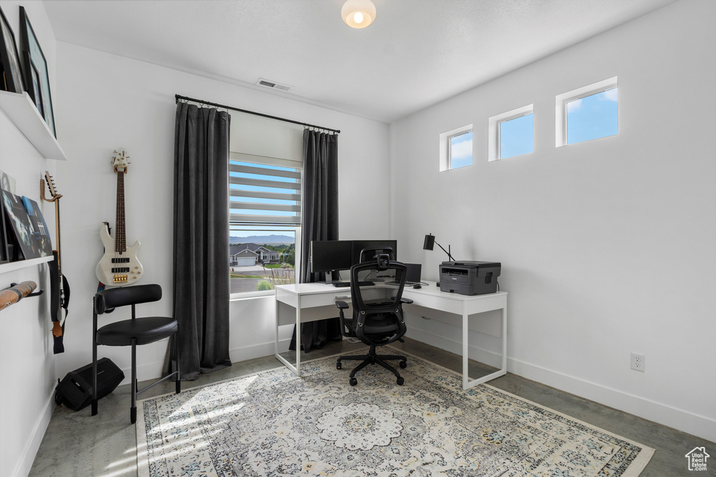 Office area with baseboards and concrete floors